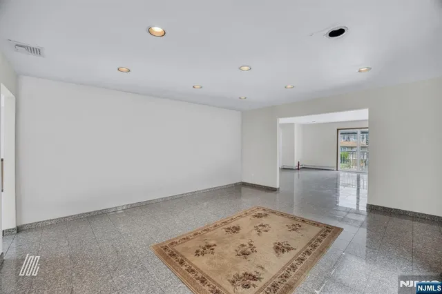 a kitchen with kitchen island a counter top space cabinets and stainless steel appliances