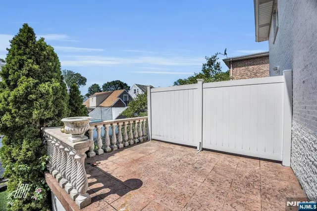 a view of a hallway with wooden floor and a bathroom