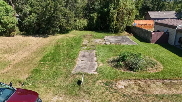 a backyard of a house with yard and trampoline