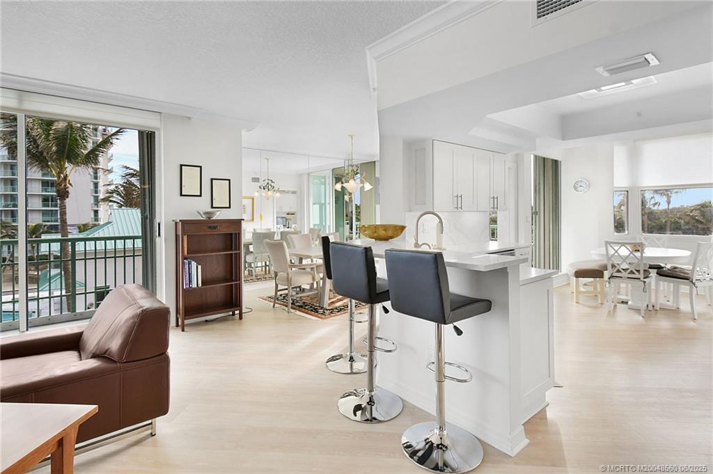 8600 South Ocean Drive, Unit 306 Jensen Beach, FL 34957 - Photo 16 of 76 a living room with furniture a fireplace and a floor to ceiling window