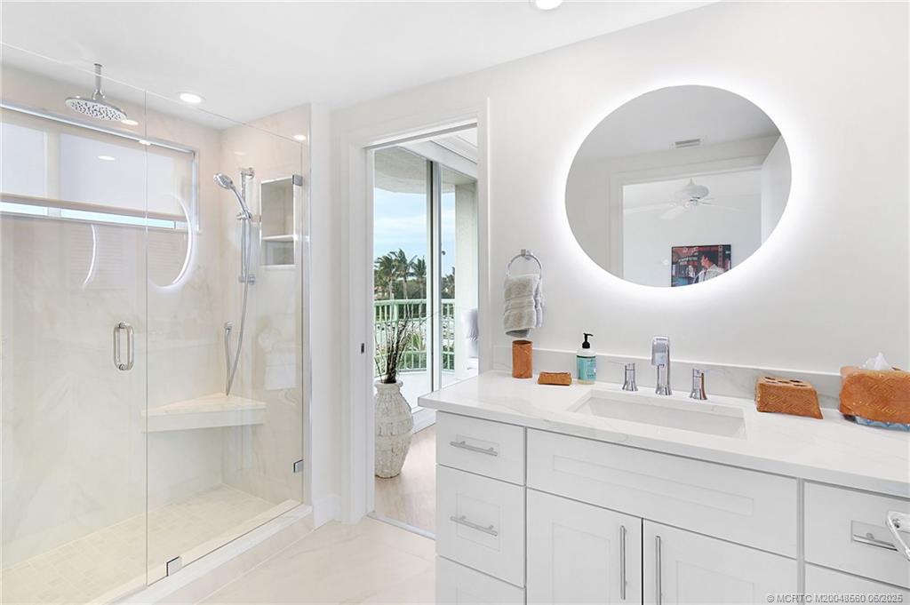 8600 South Ocean Drive, Unit 306 Jensen Beach, FL 34957 - Photo 30 of 76 a bathroom with a double vanity sink mirror and shower