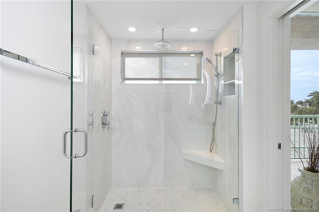 8600 South Ocean Drive, Unit 306 Jensen Beach, FL 34957 - Photo 31 of 76 a bathroom with a shower and a glass door