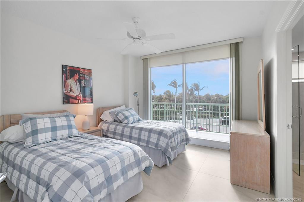 8600 South Ocean Drive, Unit 306 Jensen Beach, FL 34957 - Photo 33 of 76 a bedroom with two beds and a large window