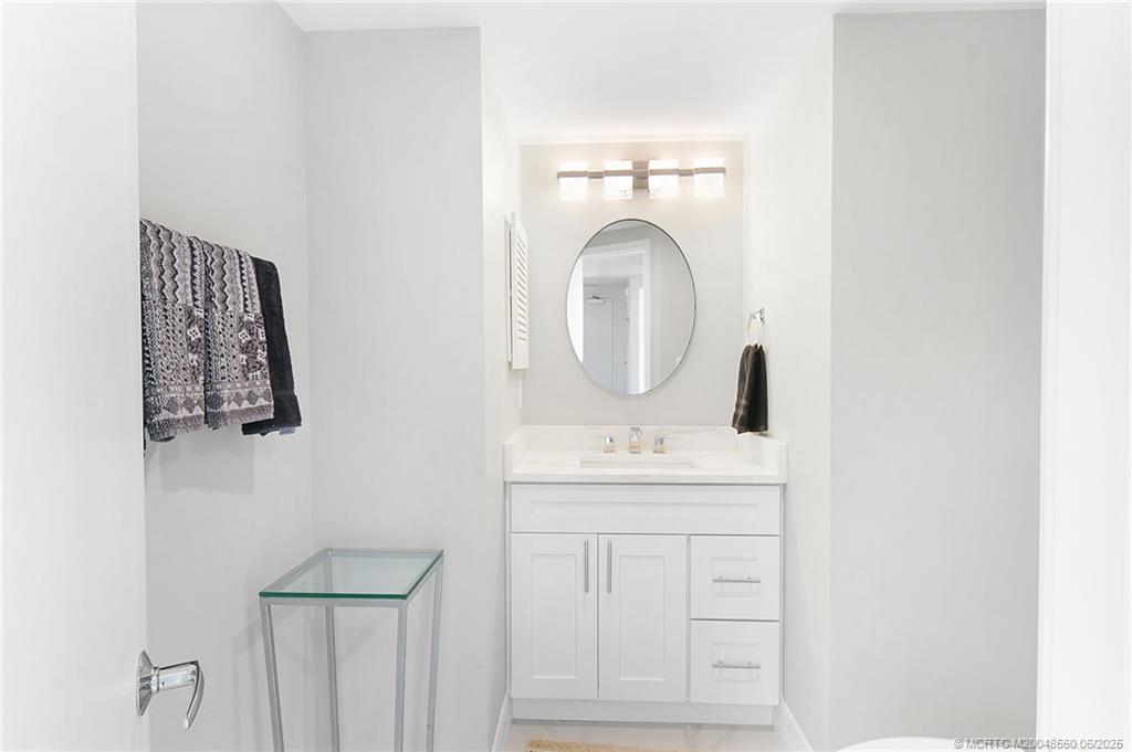 8600 South Ocean Drive, Unit 306 Jensen Beach, FL 34957 - Photo 34 of 76 a bathroom with a sink and a mirror