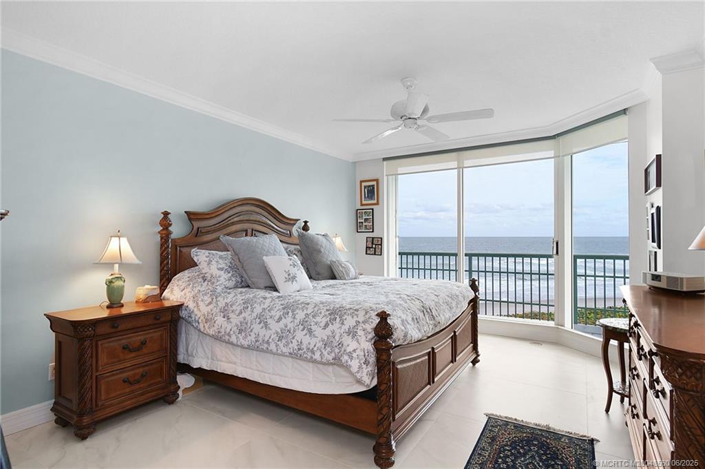 8600 South Ocean Drive, Unit 306 Jensen Beach, FL 34957 - Photo 36 of 76 a bedroom with a bed and a dresser next to a window