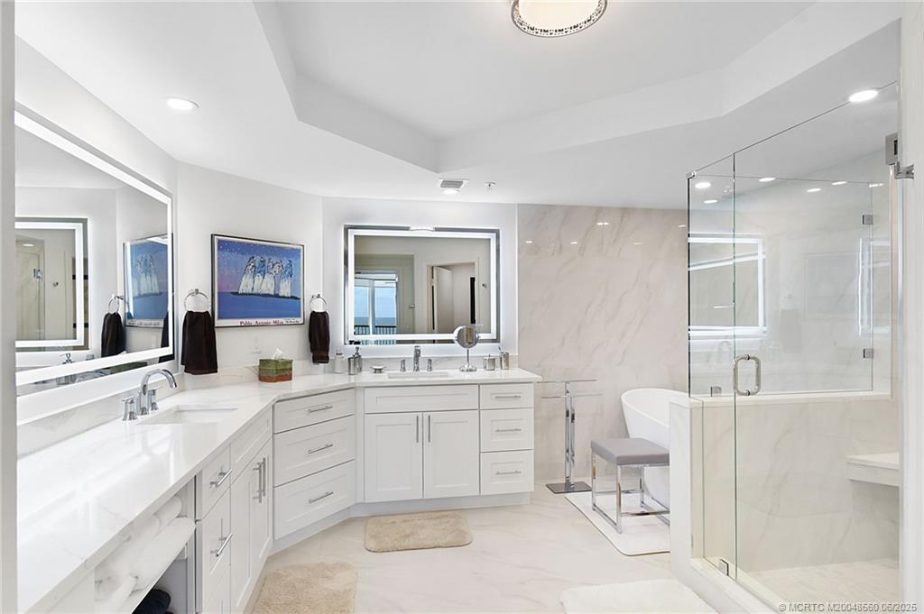 8600 South Ocean Drive, Unit 306 Jensen Beach, FL 34957 - Photo 41 of 76 a spacious bathroom with a granite countertop sink mirror and a