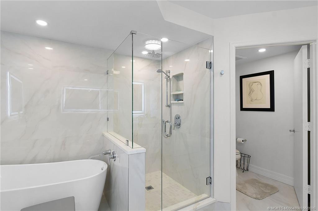 8600 South Ocean Drive, Unit 306 Jensen Beach, FL 34957 - Photo 43 of 76 a bathroom with a shower and a toilet
