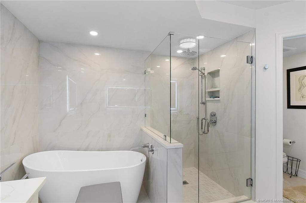 8600 South Ocean Drive, Unit 306 Jensen Beach, FL 34957 - Photo 44 of 76 a bathroom with a shower a toilet and sink