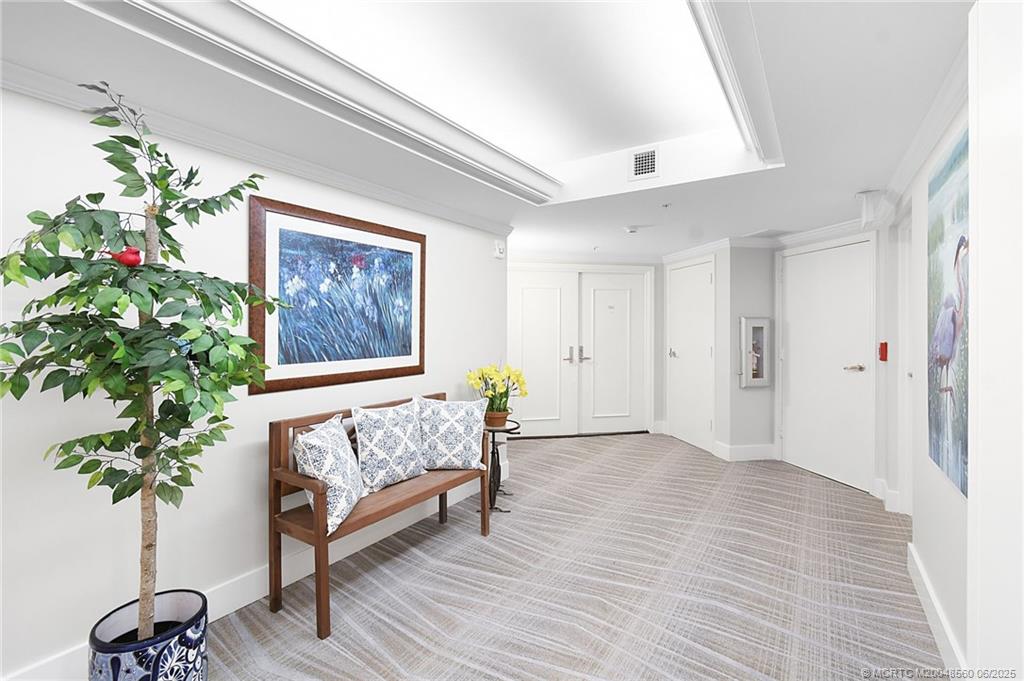 8600 South Ocean Drive, Unit 306 Jensen Beach, FL 34957 - Photo 55 of 76 a living room with furniture and a potted plant