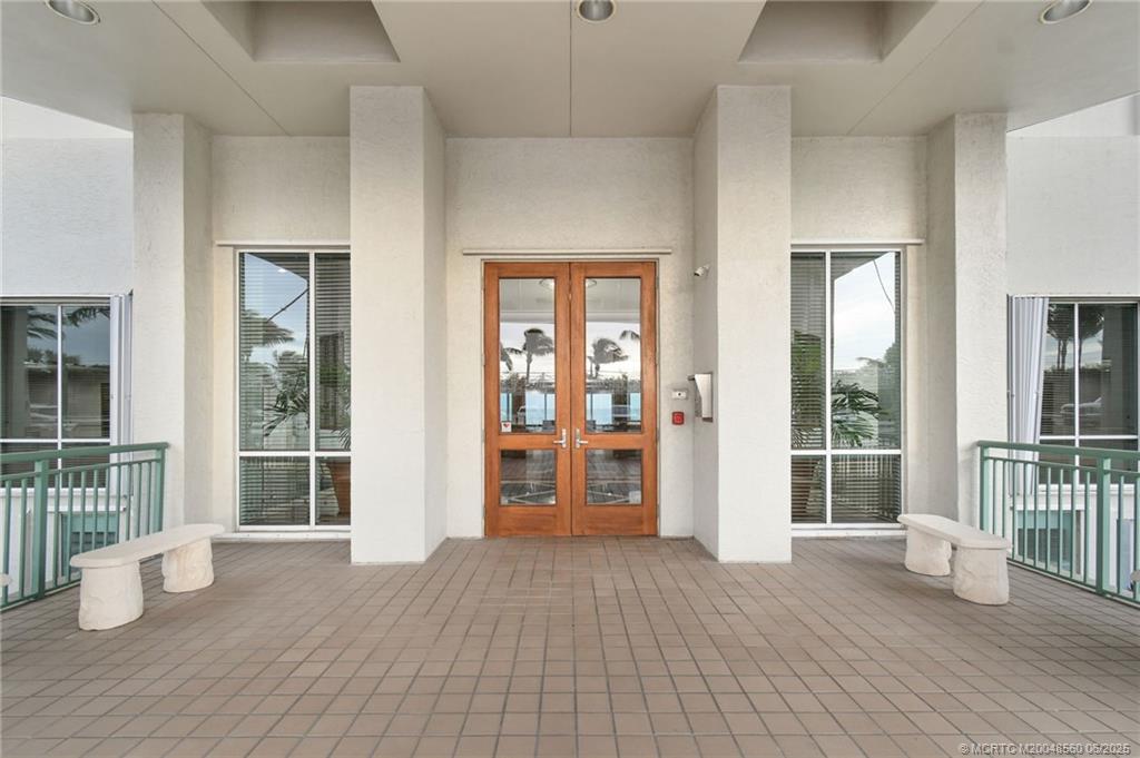 8600 South Ocean Drive, Unit 306 Jensen Beach, FL 34957 - Photo 56 of 76 an empty room with wooden floor and windows