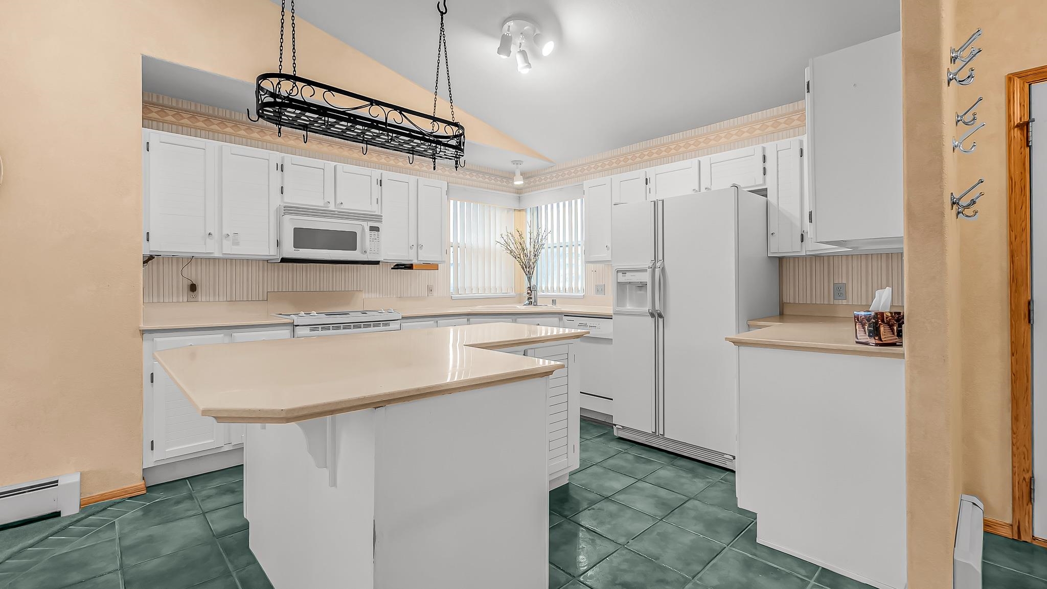 12 West Ridge Court Parachute, CO 81635 - Photo 7 of 37 a kitchen with kitchen island a sink stainless steel appliances and white cabinets