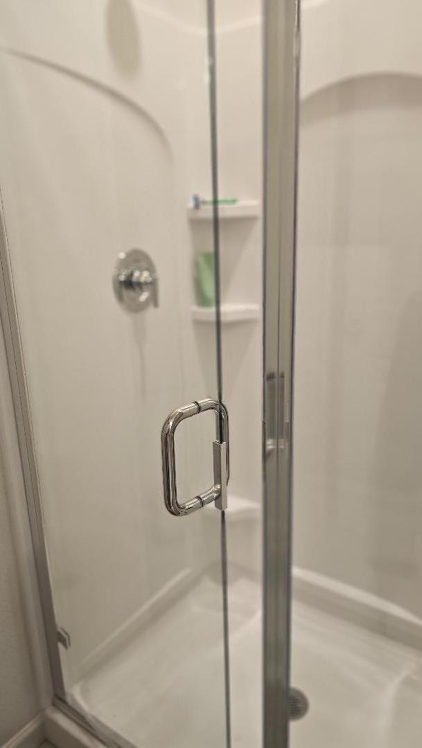 2865 Bering Street Manteca, CA 95337 - Photo 10 of 11 a bathroom with a glass shower door