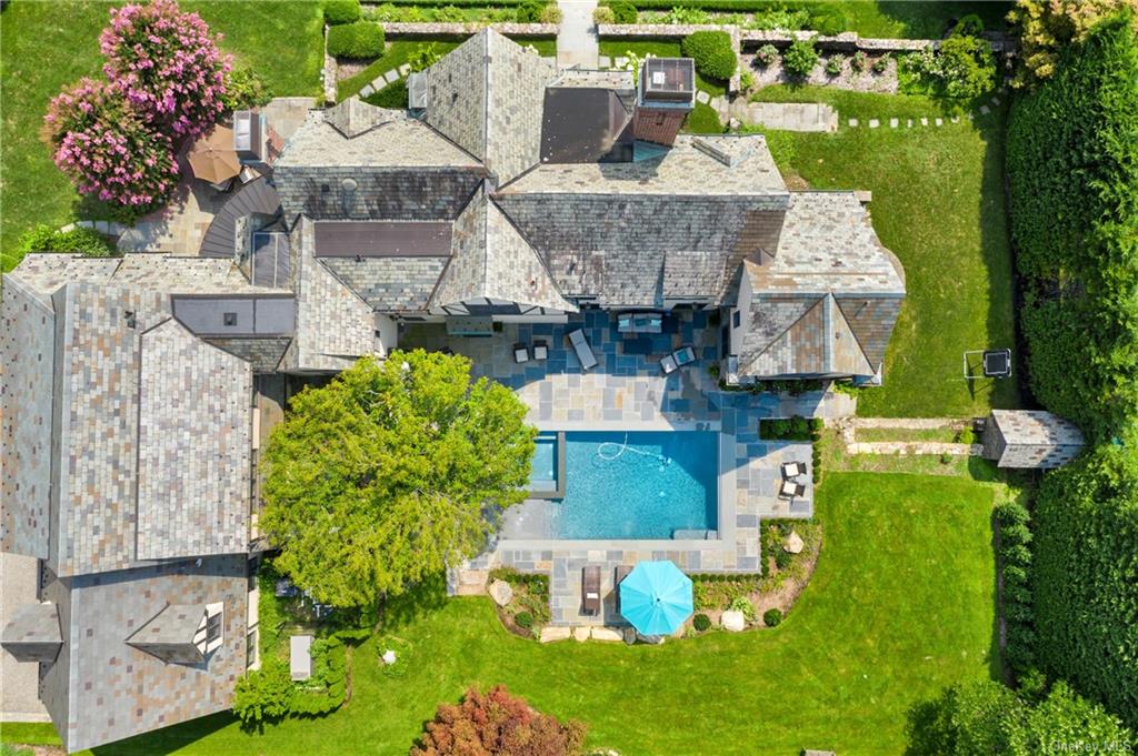 an aerial view of a house with a garden and swimming pool