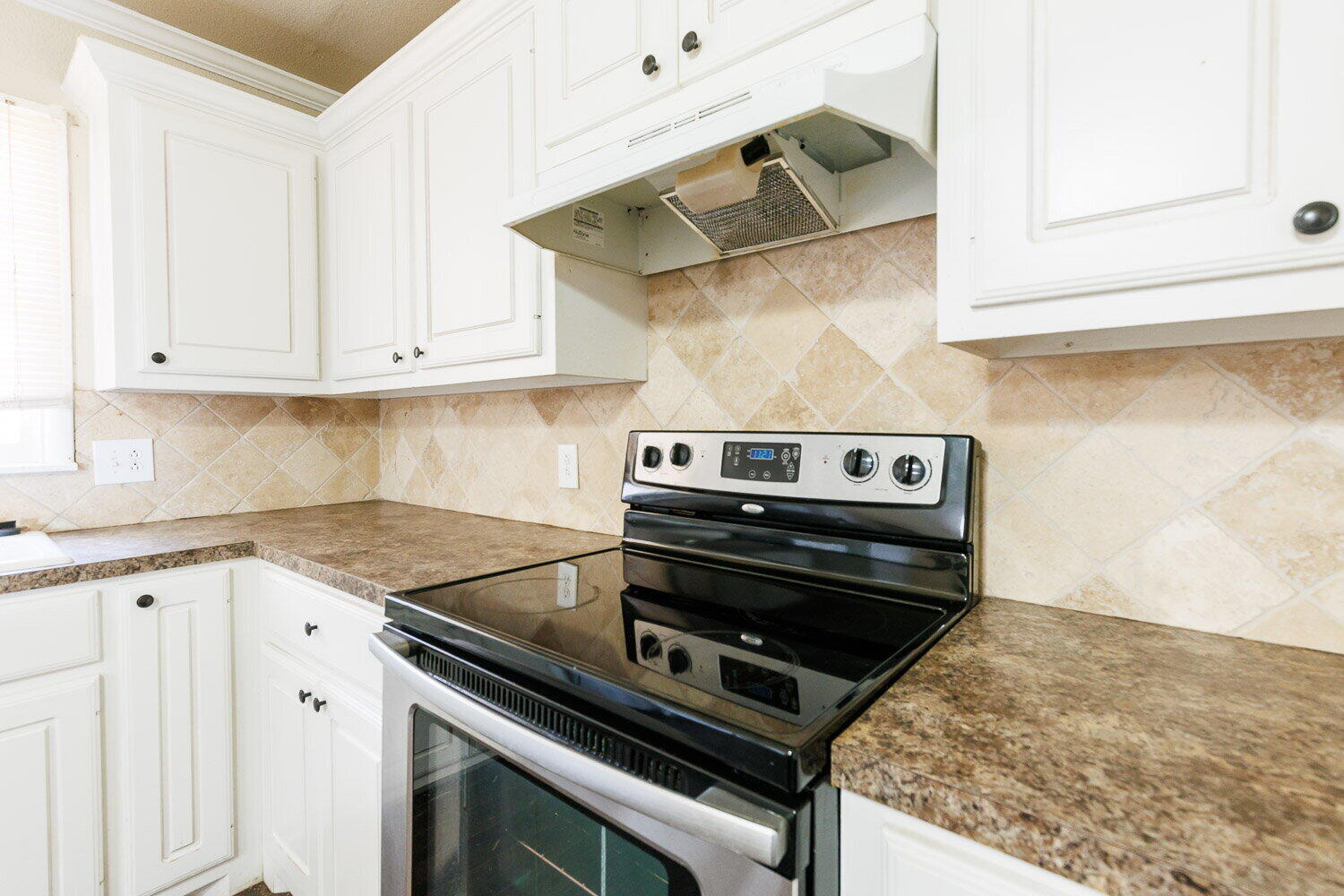 2505 52nd Street Lubbock, TX 79413 - Photo 13 of 37 a stove top oven sitting inside of a kitchen