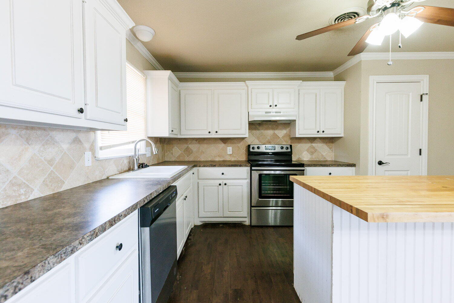 2505 52nd Street Lubbock, TX 79413 - Photo 16 of 37 a kitchen with a sink stove top oven and cabinets