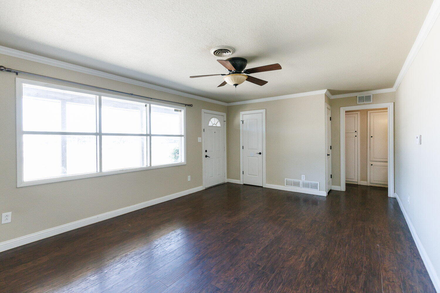 2505 52nd Street Lubbock, TX 79413 - Photo 2 of 37 a view of an empty room with wooden floor and a window