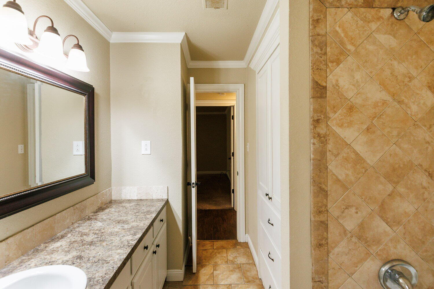 2505 52nd Street Lubbock, TX 79413 - Photo 30 of 37 a bathroom with a granite countertop sink and a mirror
