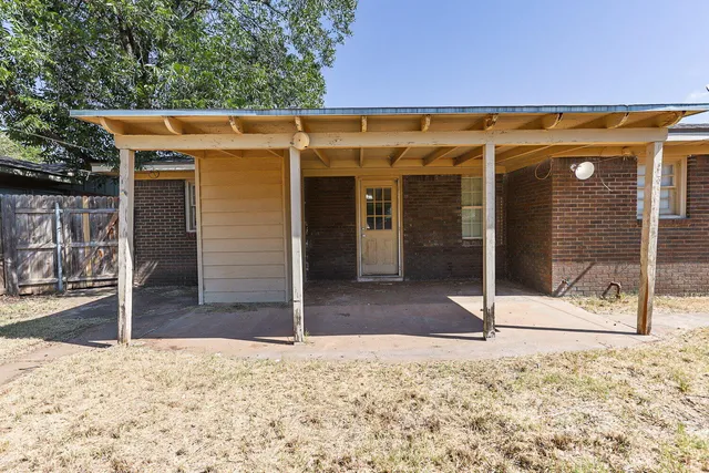 a view of a house with wooden fence