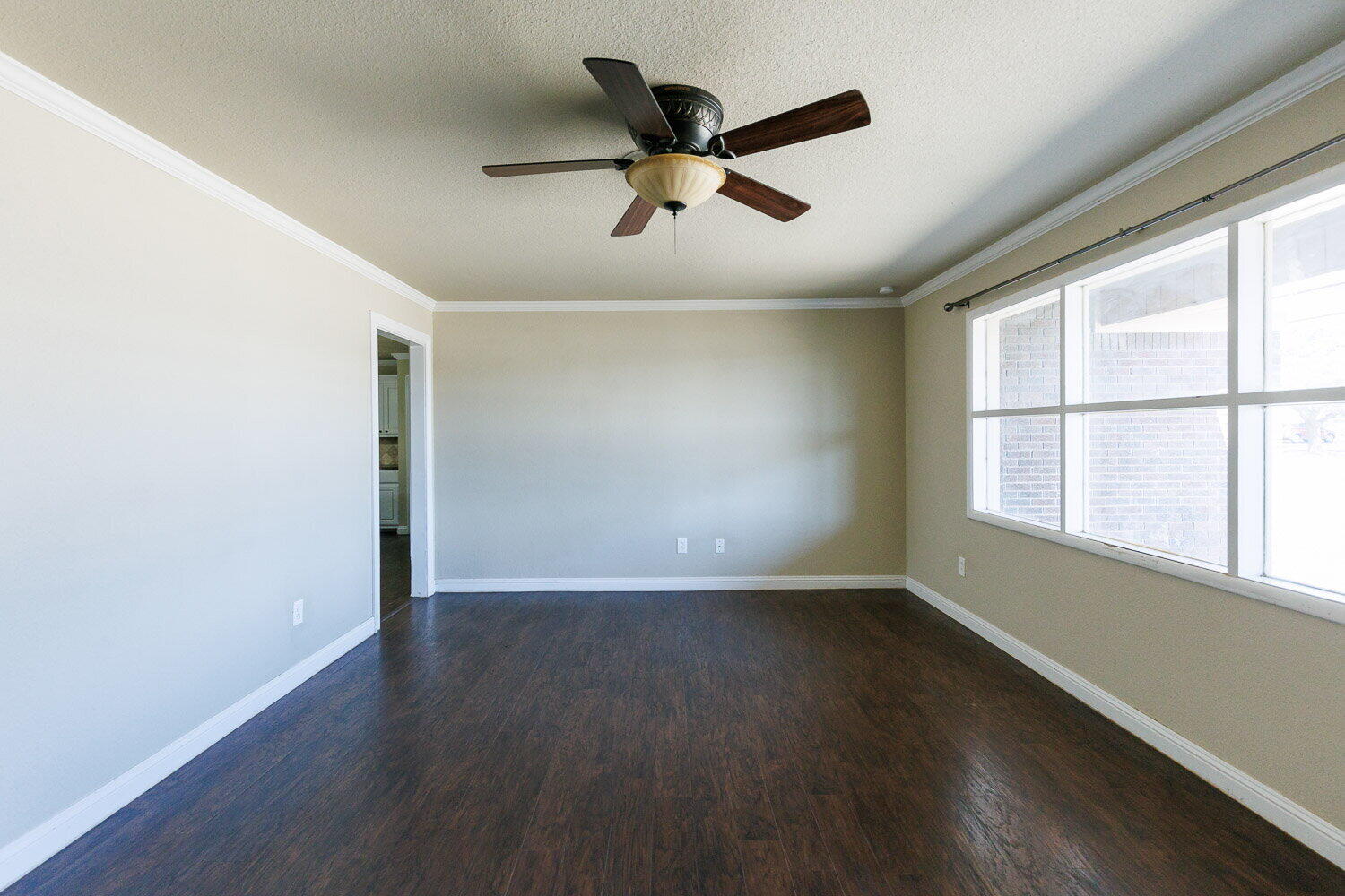 2505 52nd Street Lubbock, TX 79413 - Photo 4 of 37 an empty room with wooden floor and windows