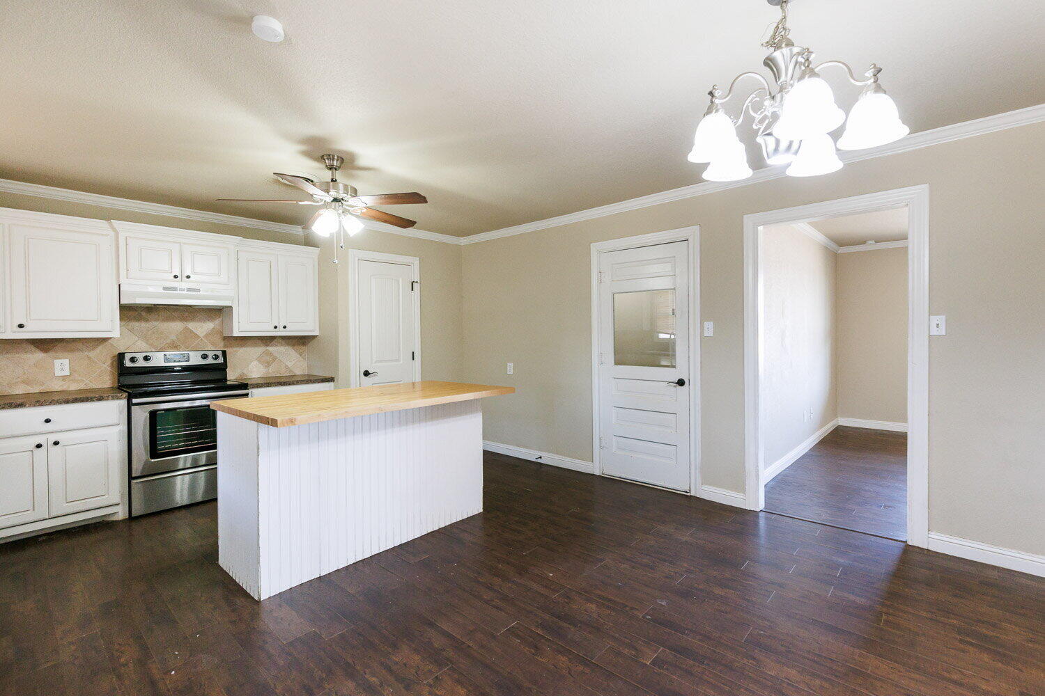 2505 52nd Street Lubbock, TX 79413 - Photo 9 of 37 a kitchen with stainless steel appliances granite countertop a stove cabinets and wooden floor