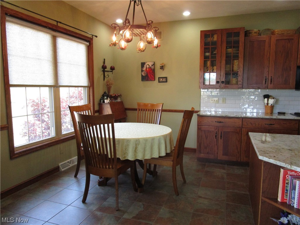 7993 Guilford Road Seville, OH 44273 - Photo 11 of 34 Off the kitchen is an eat-in kitchen while enjoying the beautiful back yard.