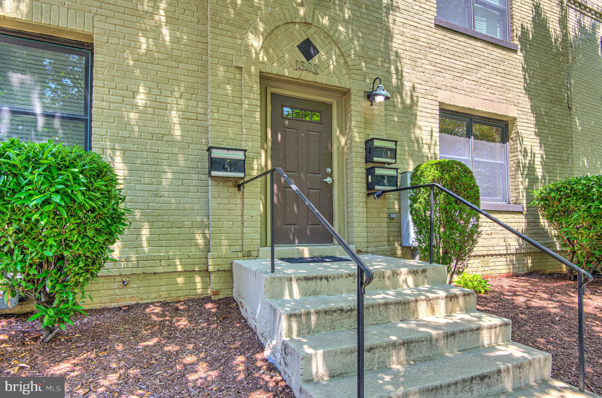 1302 Childress Street Northeast, Unit 4 Washington, DC 20002 - Photo 2 of 17 a front view of a house with a garden