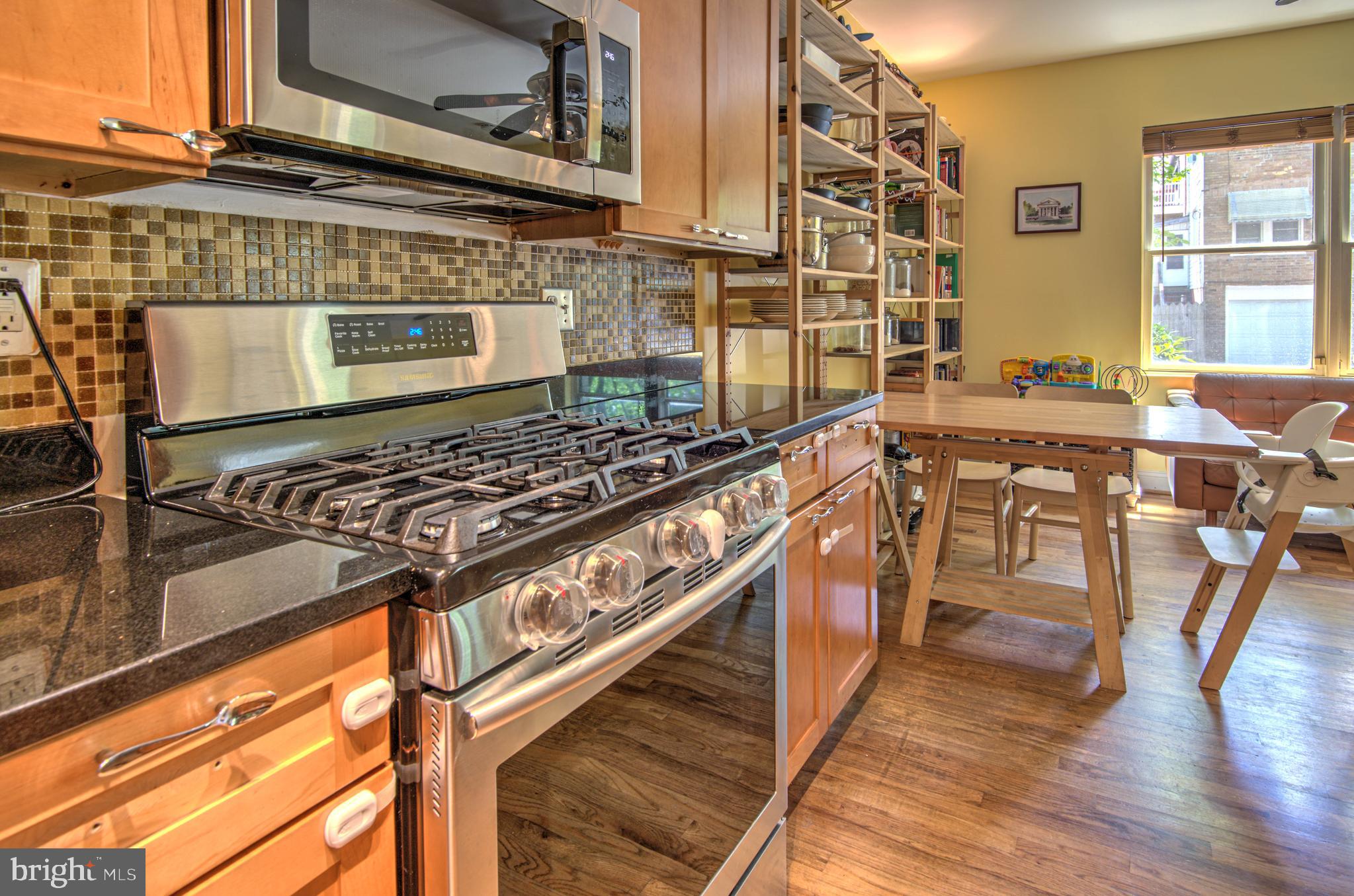 1302 Childress Street Northeast, Unit 4 Washington, DC 20002 - Photo 9 of 17 a kitchen with stainless steel appliances granite countertop a stove and cabinets