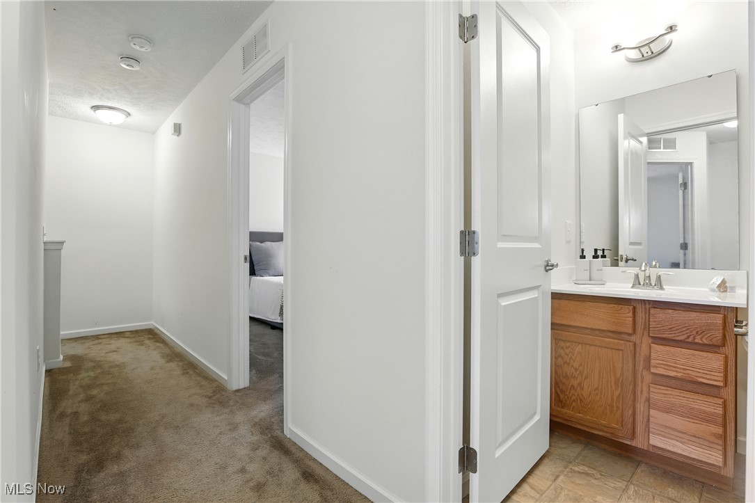 2112 Fowl Road Elyria, OH 44035 - Photo 21 of 49 Ensuite bathroom with vanity and baseboards