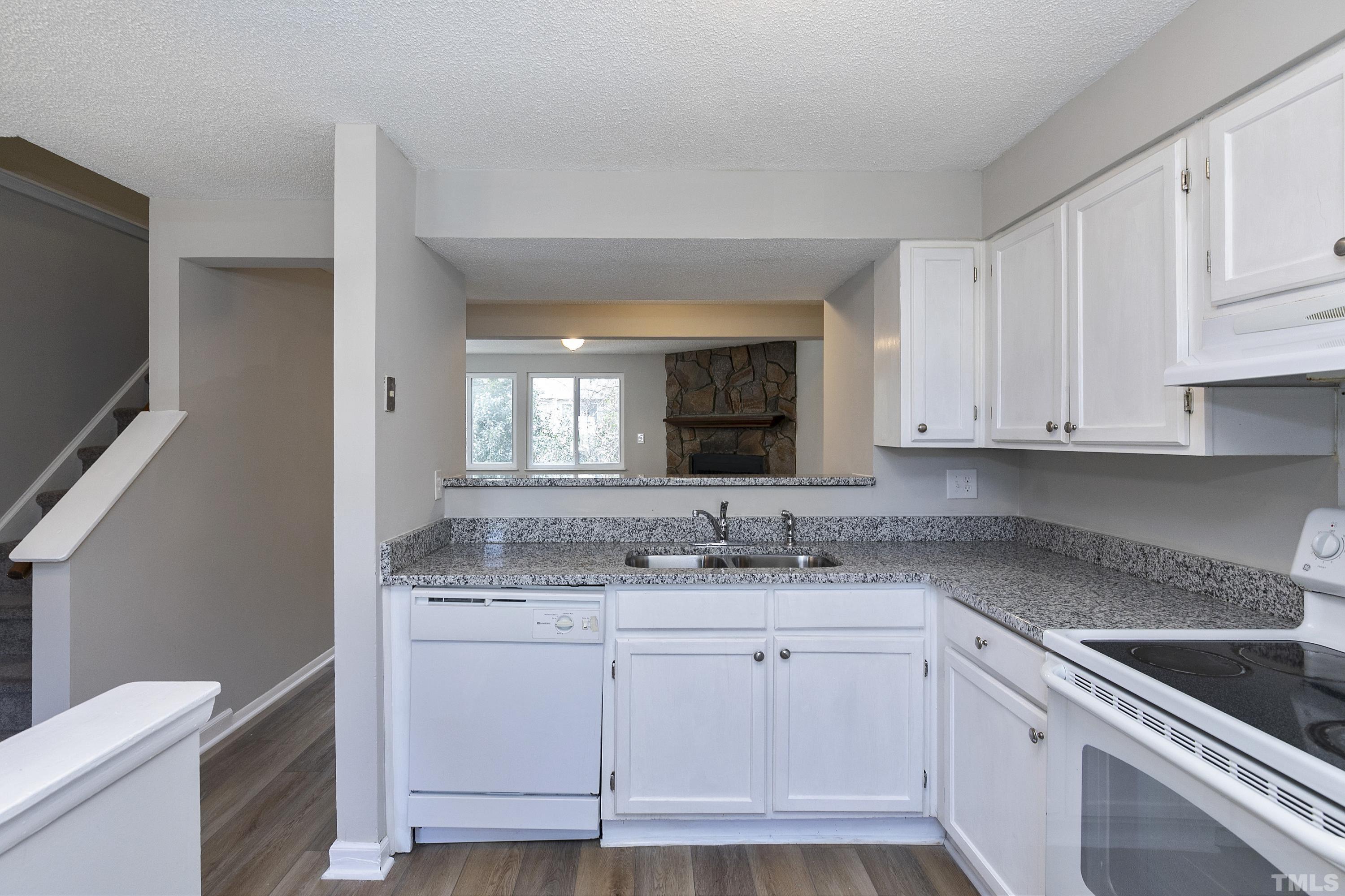 7735 Kelley Court Raleigh, NC 27615 - Photo 13 of 26 a kitchen with cabinets appliances a sink and a counter top space
