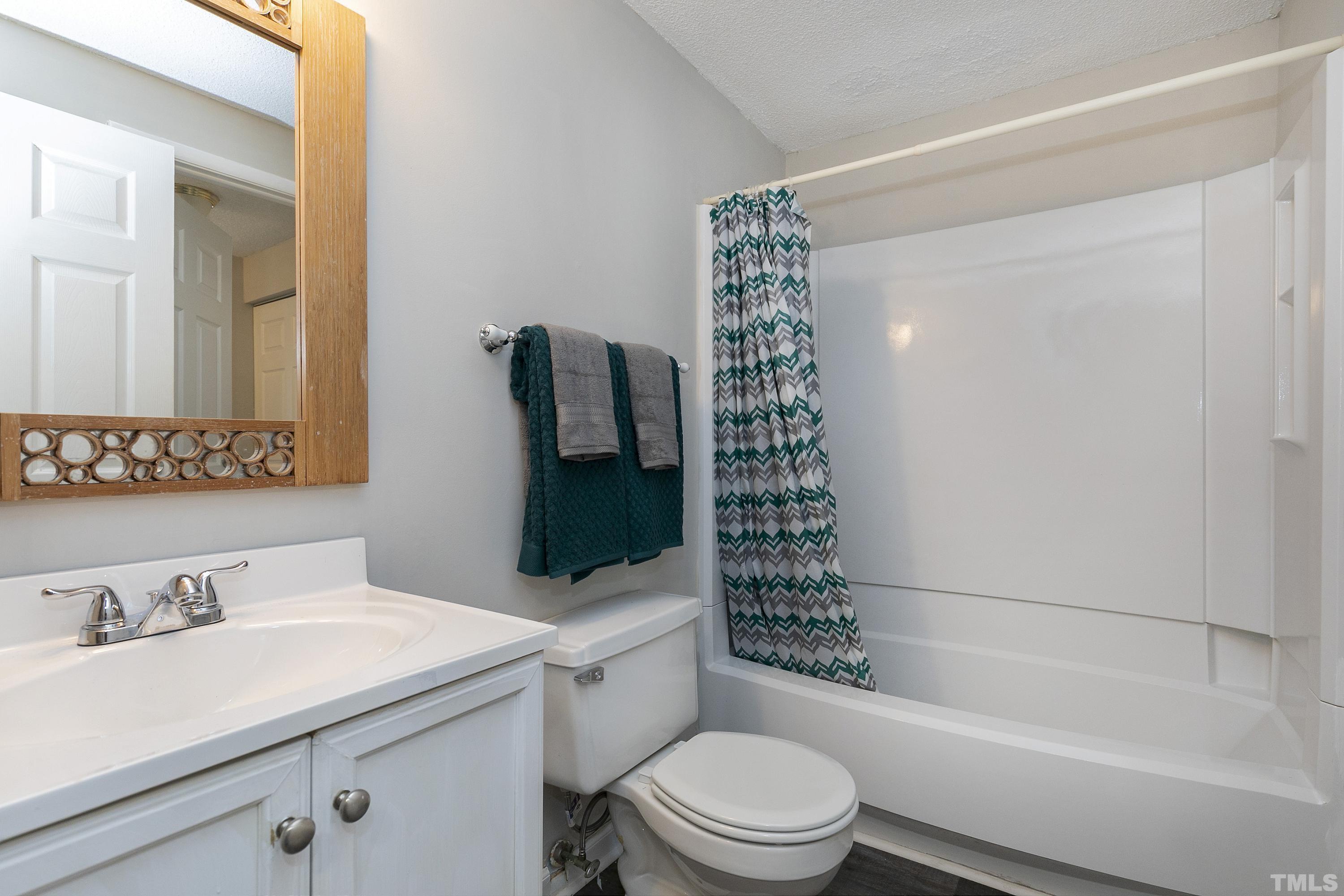 7735 Kelley Court Raleigh, NC 27615 - Photo 15 of 26 a bathroom with a sink toilet and shower
