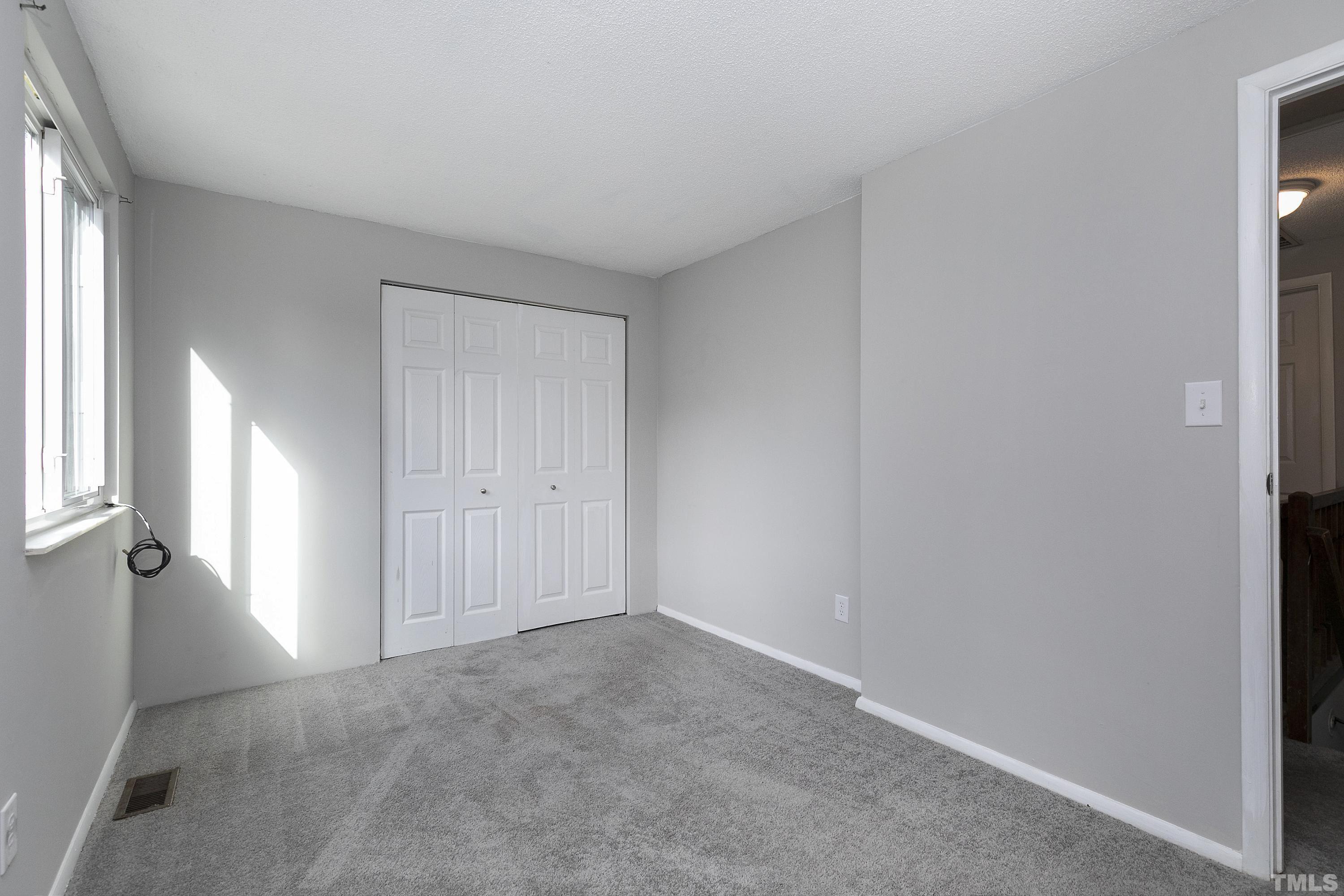 7735 Kelley Court Raleigh, NC 27615 - Photo 16 of 26 an empty room with windows