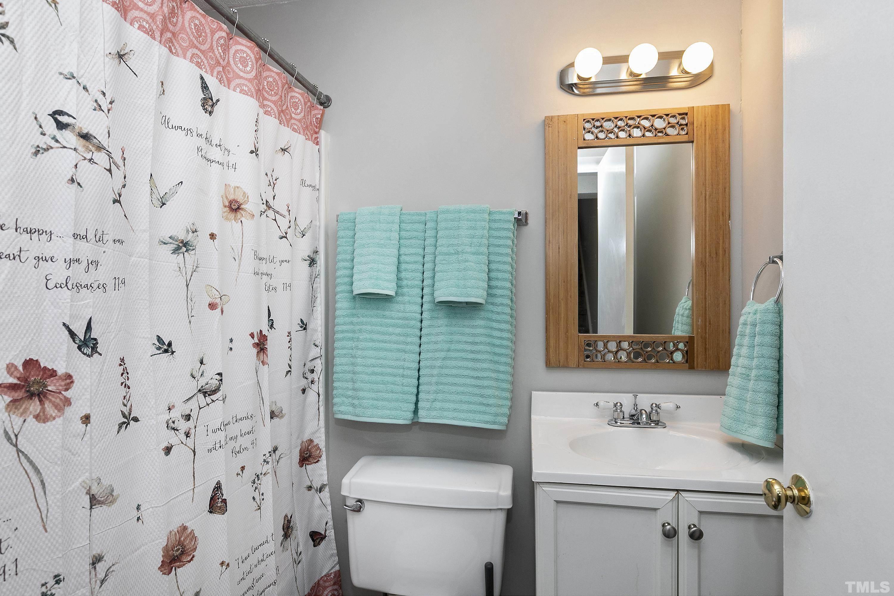 7735 Kelley Court Raleigh, NC 27615 - Photo 19 of 26 a bathroom with a sink toilet and shower
