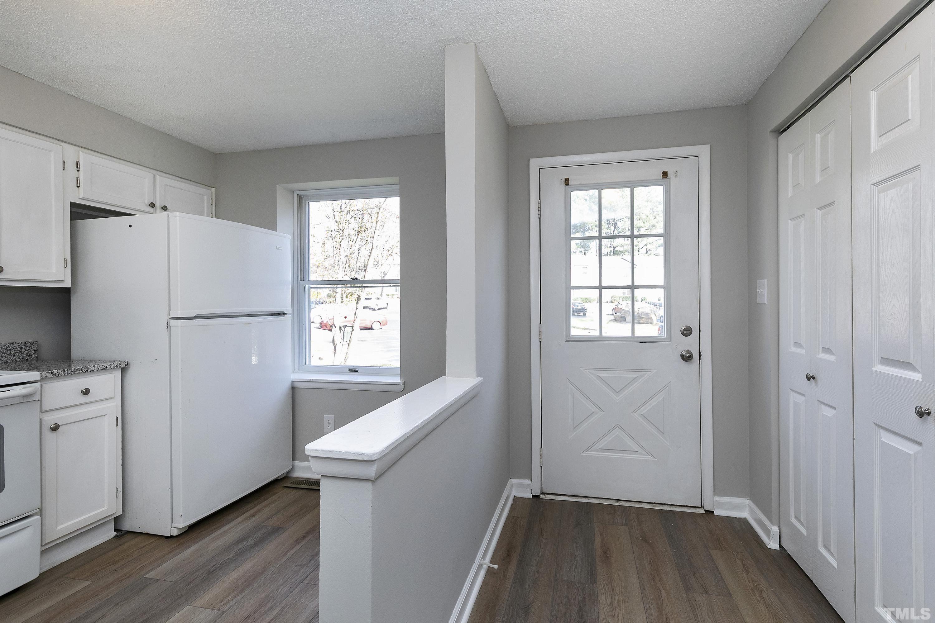 7735 Kelley Court Raleigh, NC 27615 - Photo 2 of 26 a view of a kitchen with wooden floor and electronic appliances