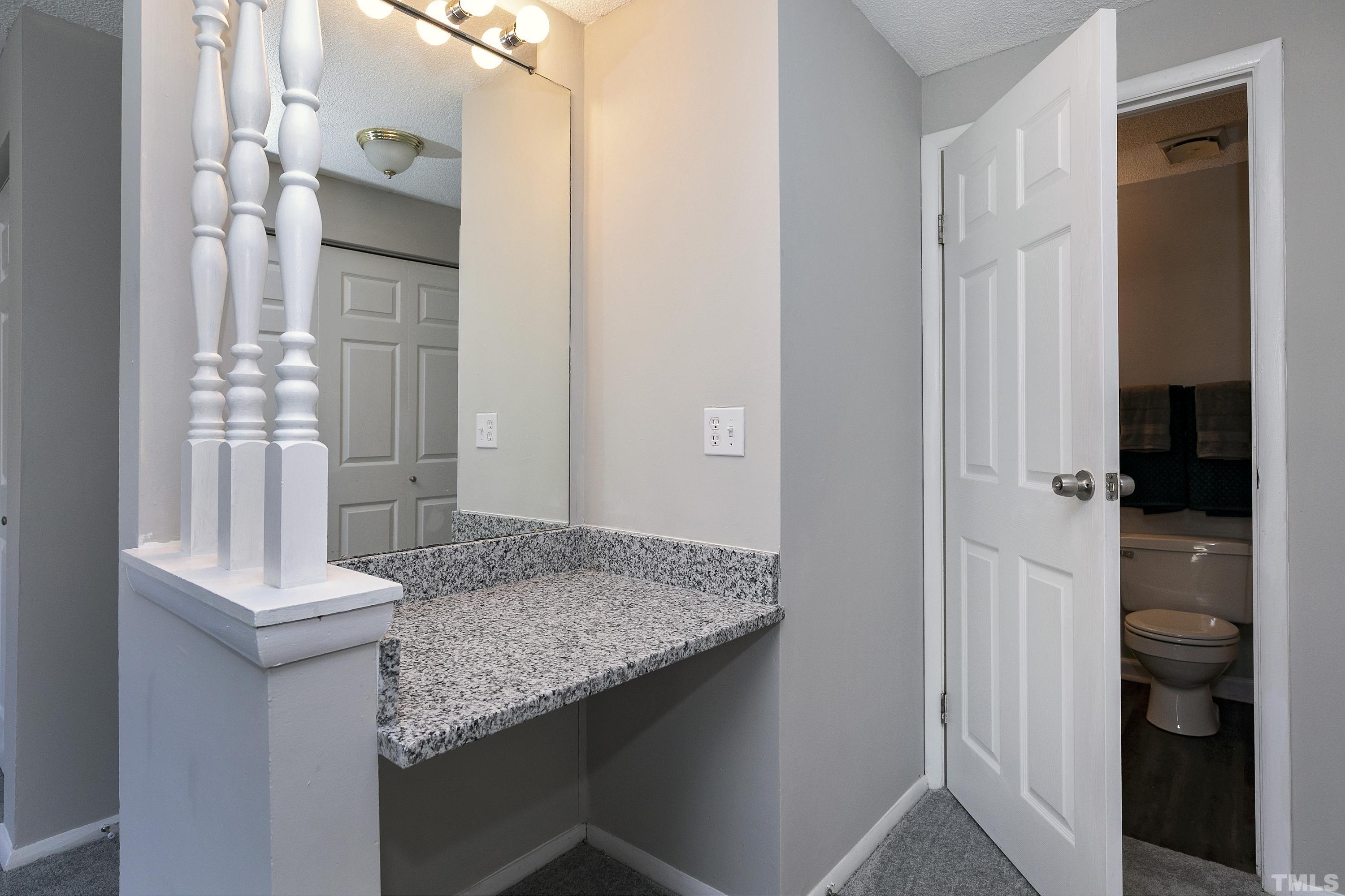 7735 Kelley Court Raleigh, NC 27615 - Photo 23 of 26 a bathroom with a granite countertop sink and a mirror