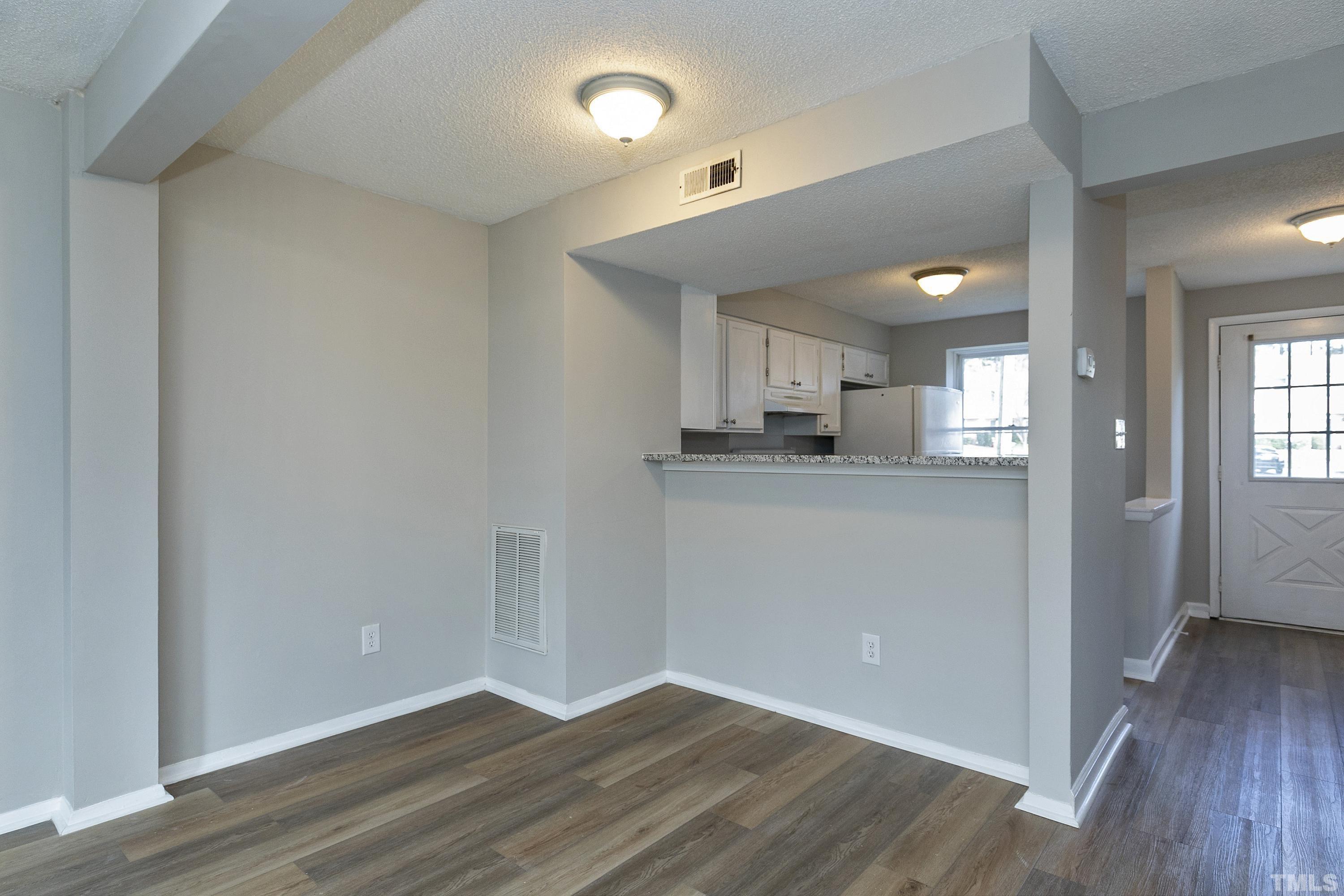 7735 Kelley Court Raleigh, NC 27615 - Photo 9 of 26 a view of a kitchen cabinets and wooden floor