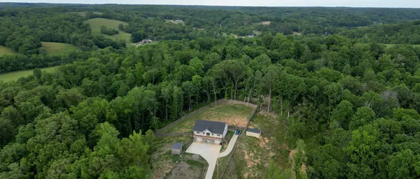 an aerial view of a house with a yard and outdoor seating