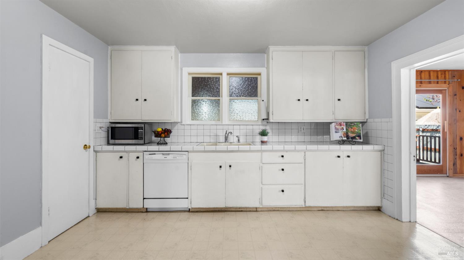125 Kendal Street Vacaville, CA 95688 - Photo 20 of 45 a kitchen with white cabinets and white appliances