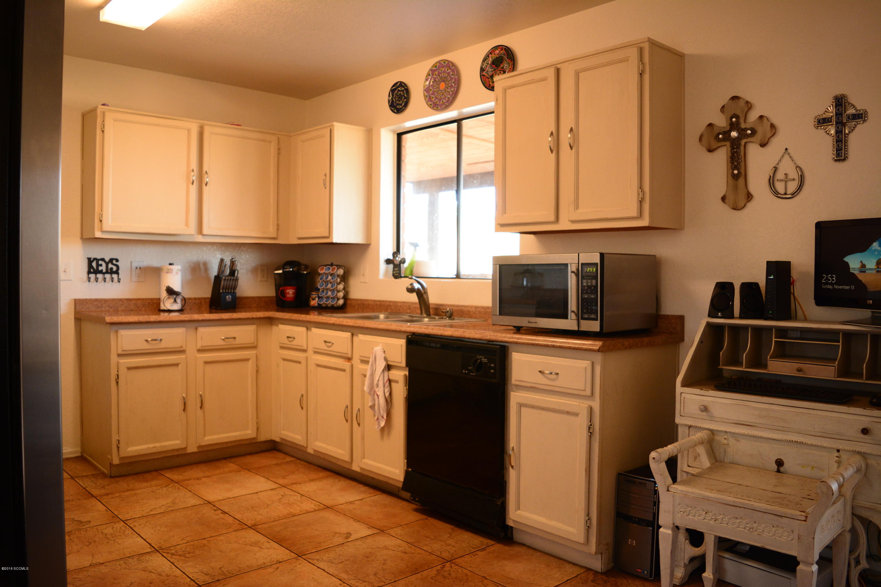 1032 Via Independencia Rio Rico, AZ 85648 - Photo 8 of 22 a kitchen with a sink cabinets and window