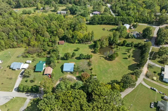 an aerial view of a houses with a yard