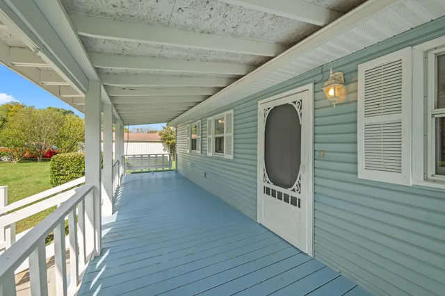 a view of a porch with wooden floor