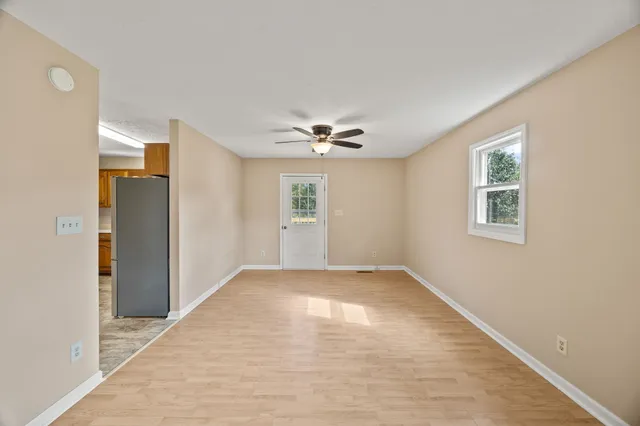 a view of a livingroom with a ceiling fan and window