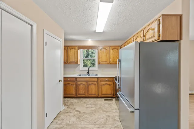 a bathroom with a granite countertop sink mirror and a bathtub