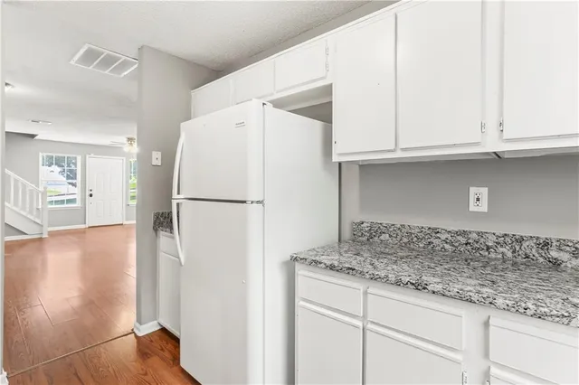 a white refrigerator freezer sitting inside of a kitchen
