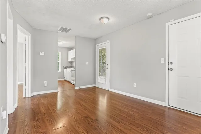 wooden floor in an empty room with a window