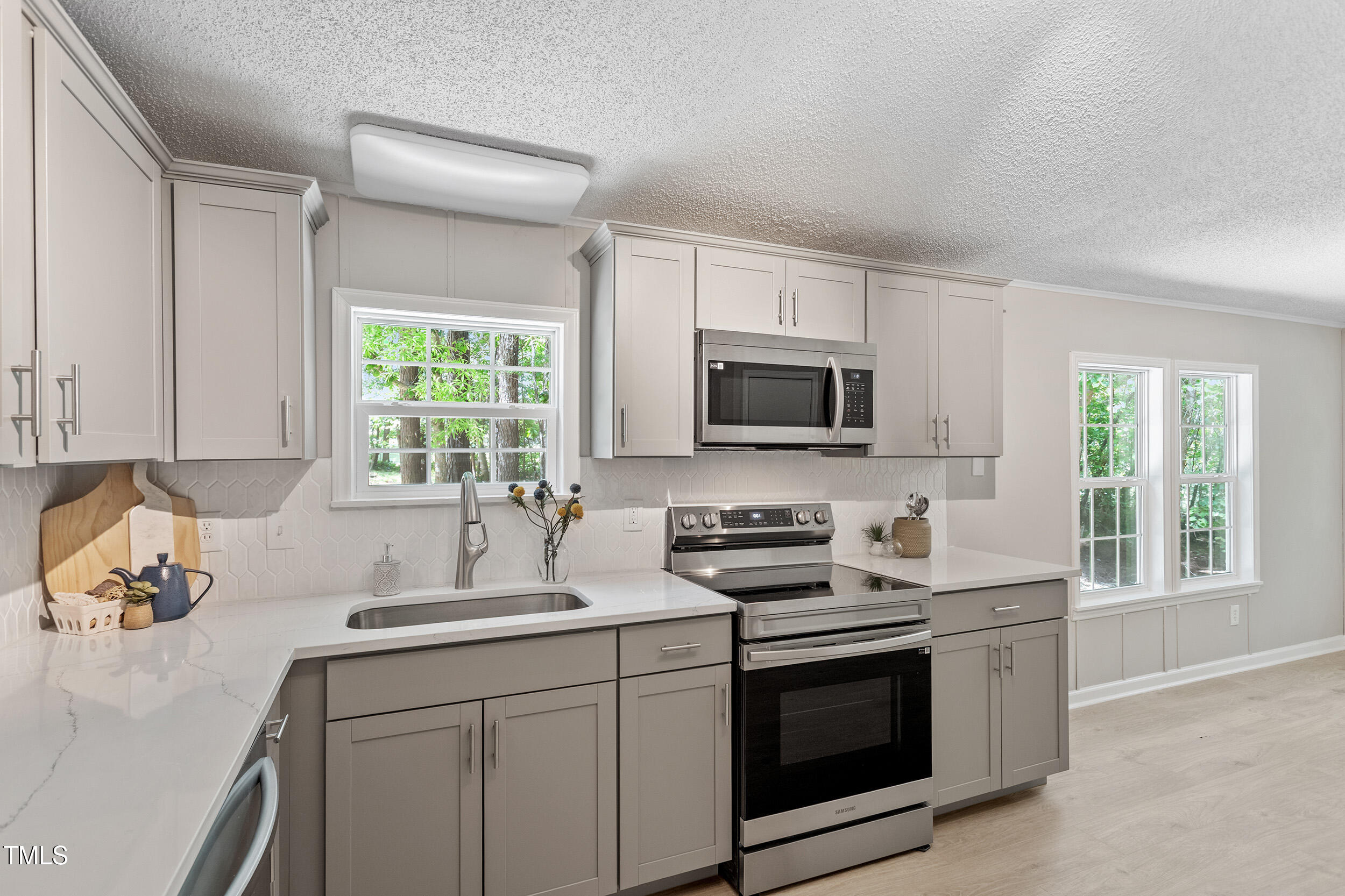 12237 Burgess Road Middlesex, NC 27557 - Photo 10 of 35 a kitchen with stainless steel appliances a stove a sink a microwave and cabinets