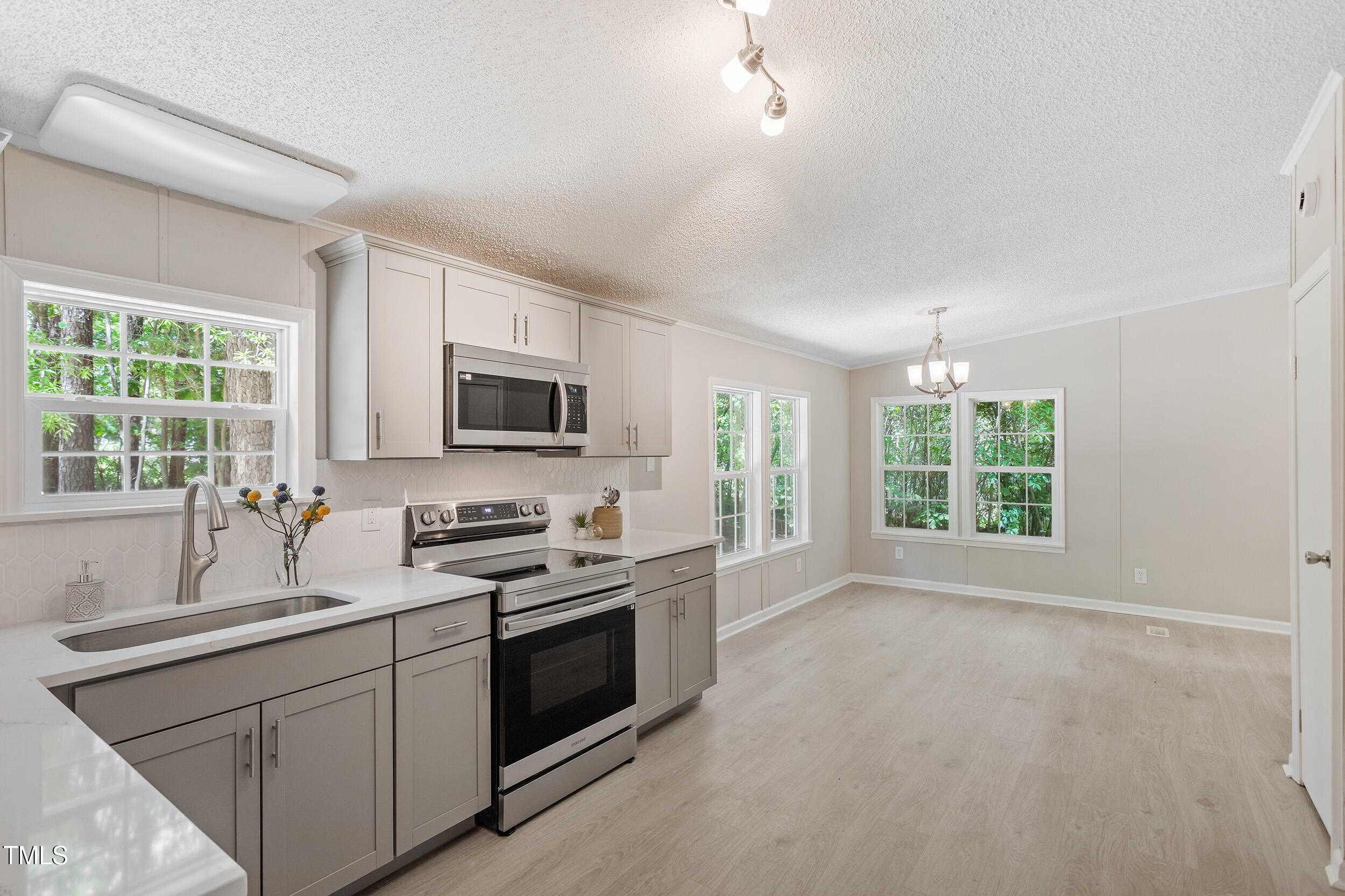 12237 Burgess Road Middlesex, NC 27557 - Photo 11 of 35 a kitchen with stainless steel appliances granite countertop a stove a sink and a microwave