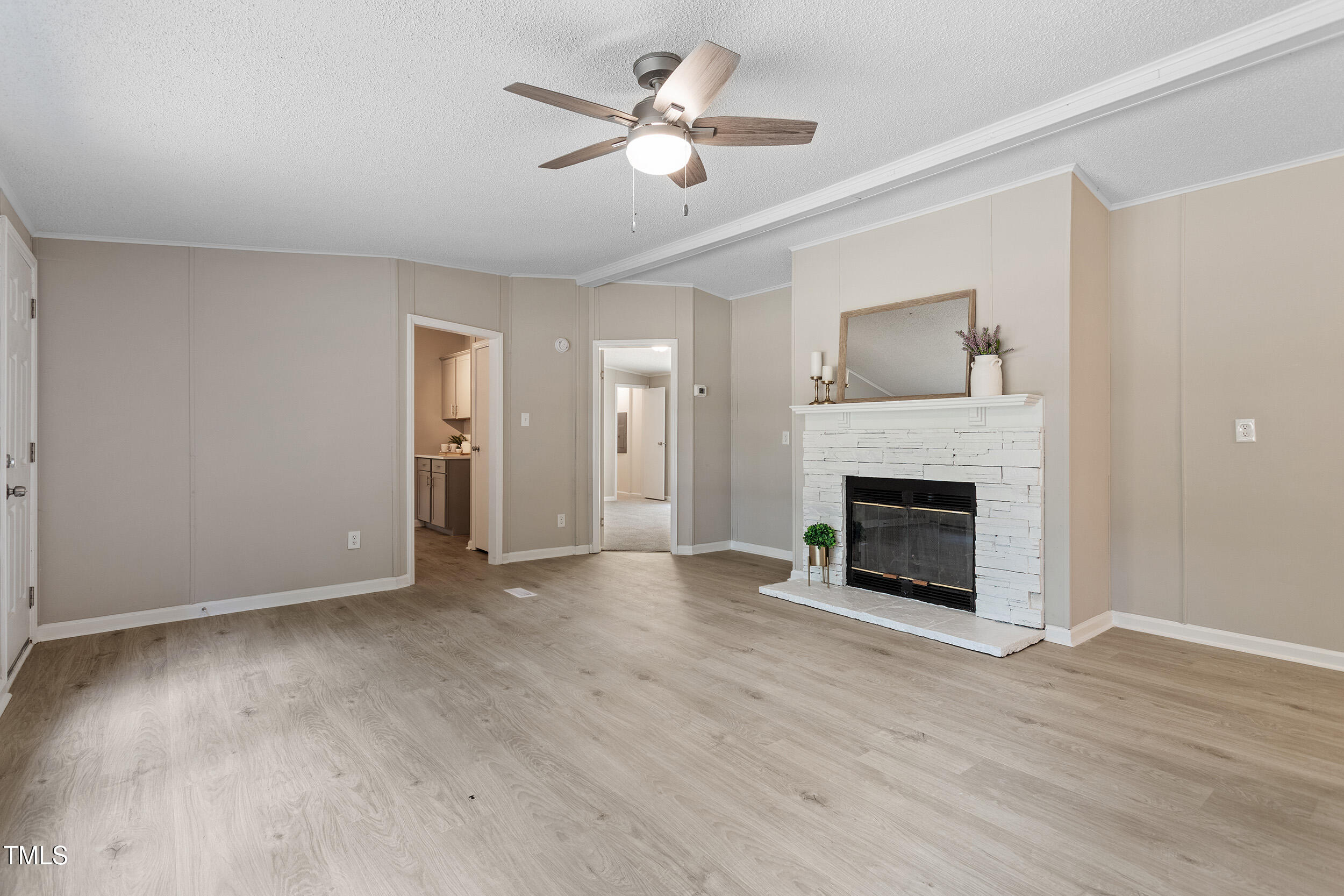 12237 Burgess Road Middlesex, NC 27557 - Photo 18 of 35 a view of a livingroom with a fireplace a ceiling fan a fireplace and entryway