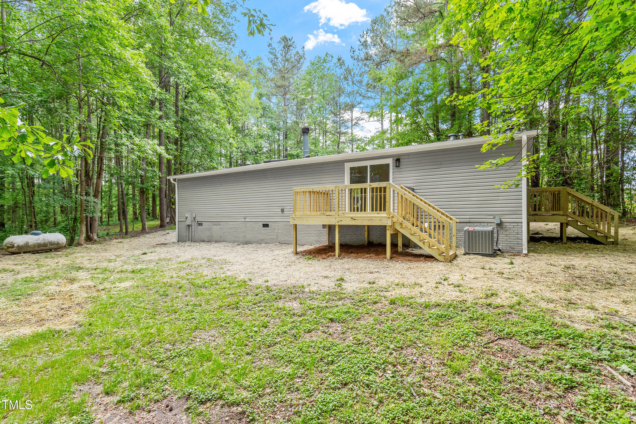 12237 Burgess Road Middlesex, NC 27557 - Photo 29 of 35 a house with trees in front of it