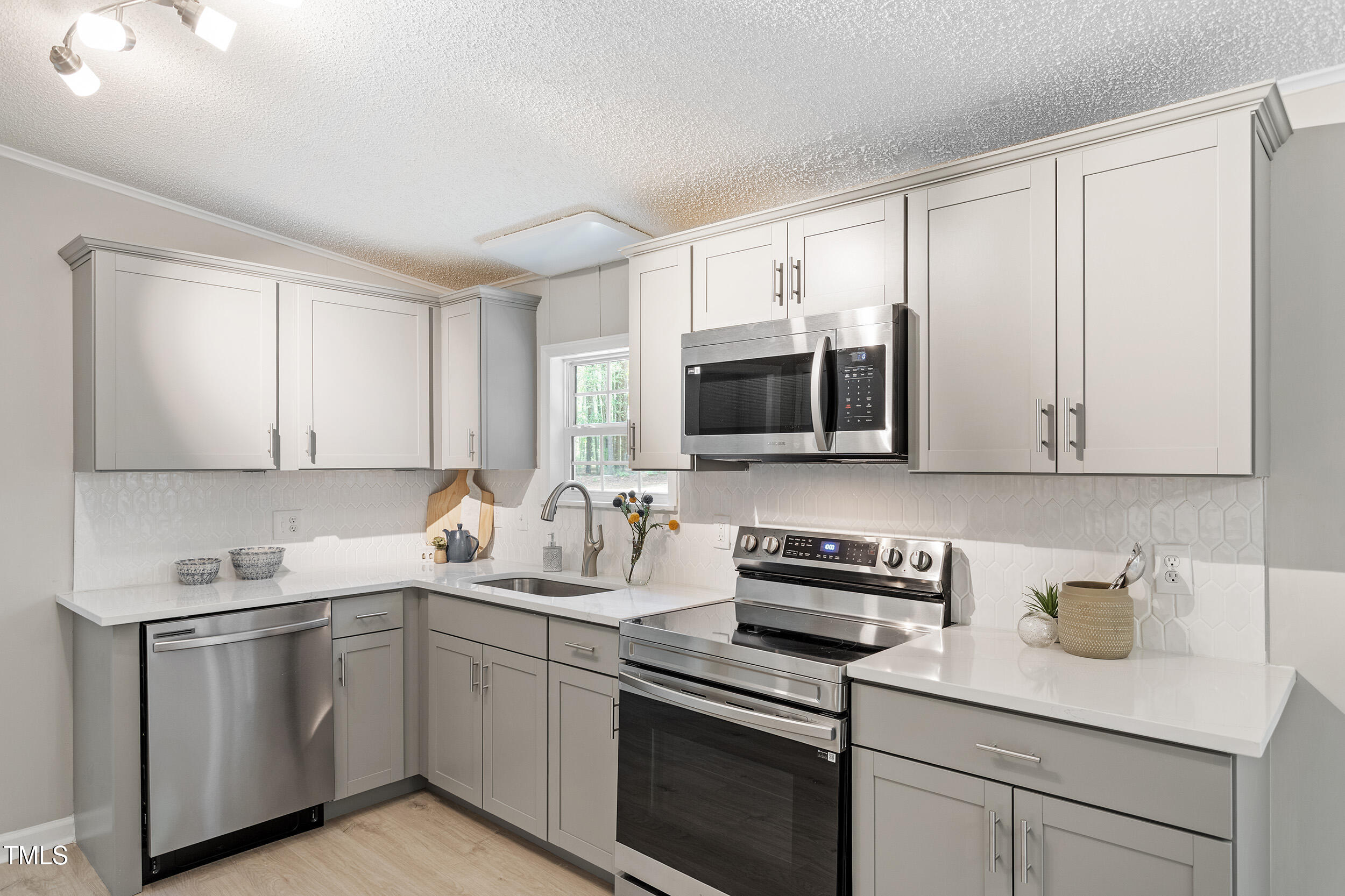 12237 Burgess Road Middlesex, NC 27557 - Photo 2 of 35 a kitchen with sink a microwave and cabinets
