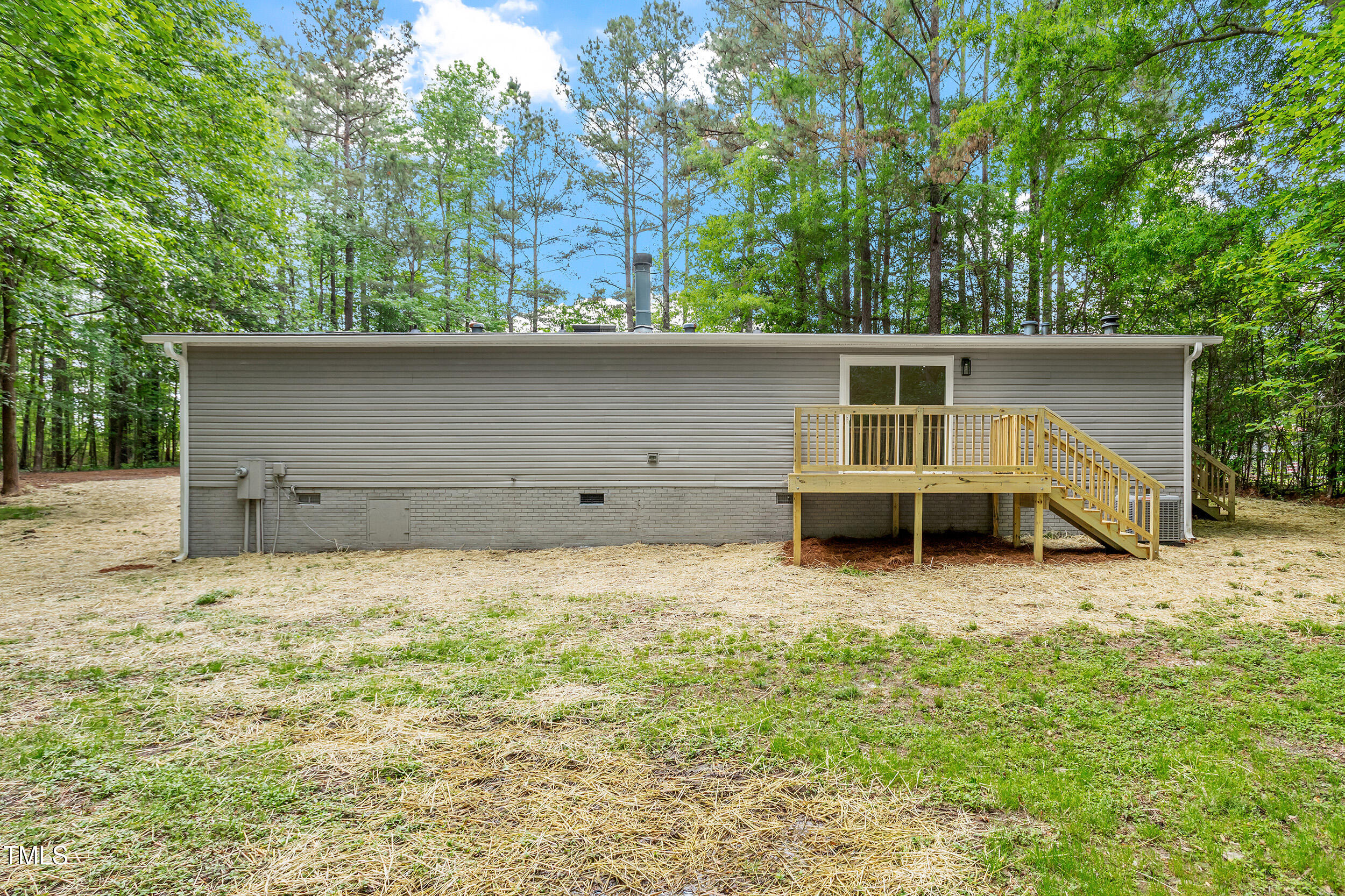 12237 Burgess Road Middlesex, NC 27557 - Photo 30 of 35 a house with trees in the background